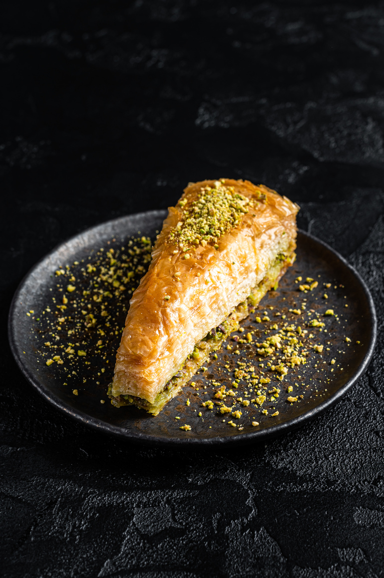 Turkish Havuc Dilim Baklava with pistachio, Carrot Slice Baklava.  Black background. Top view