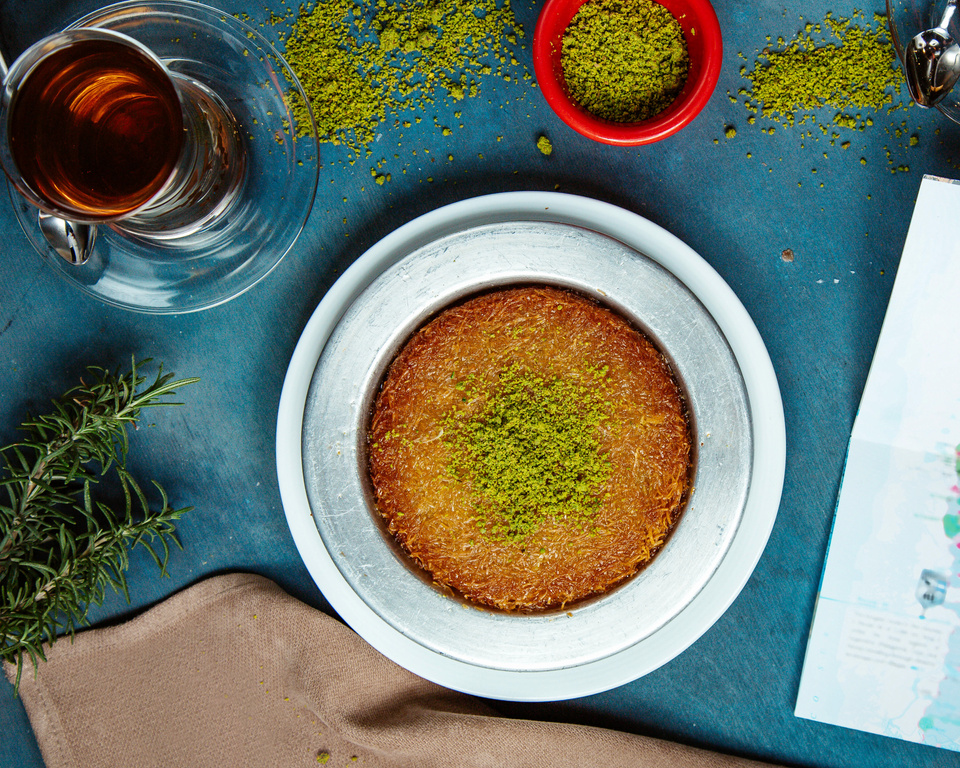 Kunefe Dessert Garnished with Pistachio Served with Black Tea