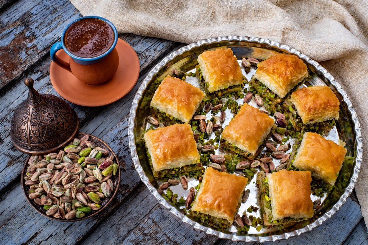 Baklava with pistachio in the plates with coffee. Carrot piece ( havuc dilim ) and dry ( kuru ) baklava.